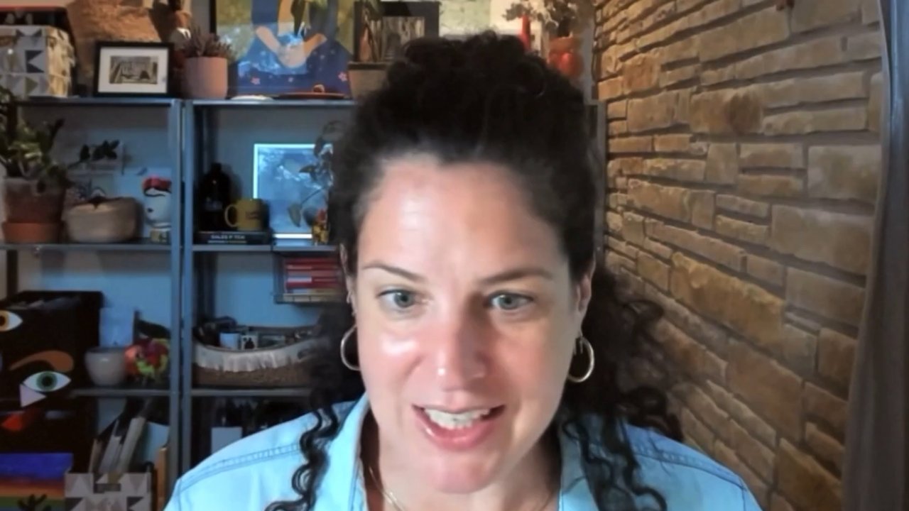 Talya Heller, founder of Down to a T, on a video call in front of a brick wall and shelves